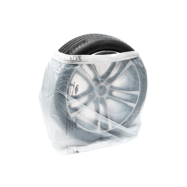 Das Bild zeigt einen Autoreifen, der in einem transparenten Plastikbeutel verpackt ist. Der Reifen ist sauber und hat ein markantes Felgendesign, das durch den Beutel sichtbar ist. Der Beutel hat Schriftzüge, die auf umweltfreundliche oder schützende Eigenschaften hinweisen könnten. Der Hintergrund ist einfarbig weiß, was den Fokus auf den verpackten Reifen lenkt.